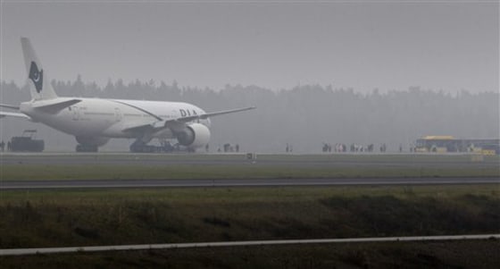 A Pakistan International Airlines Boeing 777 plane sits on the tarmac at Stockholm Arlanda International airport on Saturday. The aircraft was en route from Toronto to Karachi when Canadian authorities received a tip-off that a passenger could be carrying explosives and the plane was diverted to Stockholm. Swedish police detained a man, but a bomb squad that searched the plane found nothing suspicious on board.
